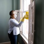 Homeowner performing seasonal home maintenance